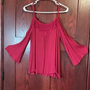 Flare long sleeve, peekaboo top. Adjustable straps,lace design in front.